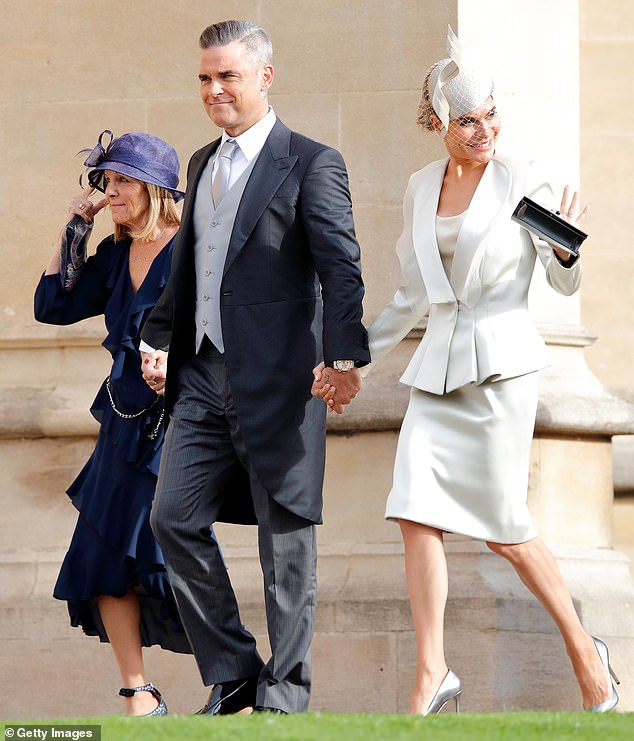 Robbie Williams and Ayda Field are pictured attending Princess Eugenie's wedding in 2018