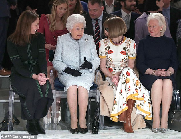 Queen Elizabeth,and royal dressmaker Angela Kelly, views British designer Richard Quinn's runway show before presenting him with the inaugural Queen Elizabeth II Award for British Design, during her visit to London Fashion Week's BFC Show Space in central London on February 20, 2018. / AFP PHOTO / POOL / Yui Mok (Photo credit should read YUI MOK/AFP/Ge