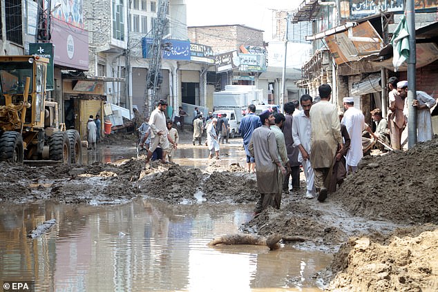 People survey damage caused by flash floods in Swat, Pakistan, 16 August 2025