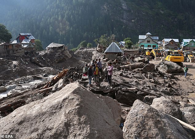 Emergency teams work in the cloudburst-hit village of Chisoti, in the Kishtwar district of Jammu and Kashmir, India, 16