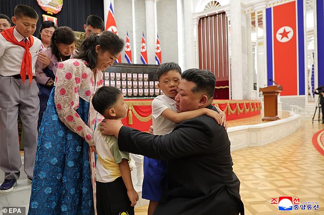 The tyrant oversaw a service where he decorated returning soldiers and consoled children of the bereaved with hugs, state media said on Friday