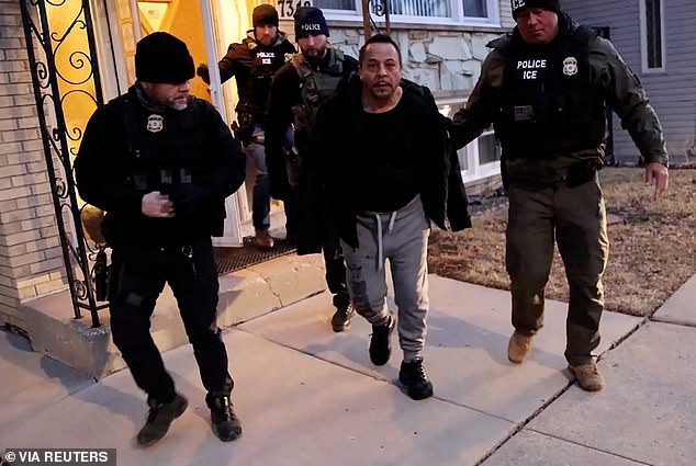 U.S. Immigration and Customs Enforcement (ICE) agents conduct an arrest as part of U.S. President Donald Trump's wide-ranging immigration crackdown in Chicago on January 26