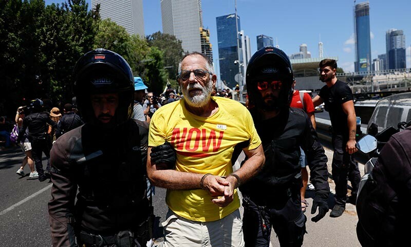 Police escort a handcuffed demonstrator during a protest, after families of hostages have called for a nationwide strike to demand the return of all hostages and an end to the war on Gaza, in Tel Aviv, Israel, August 17, 2025. — Reuters