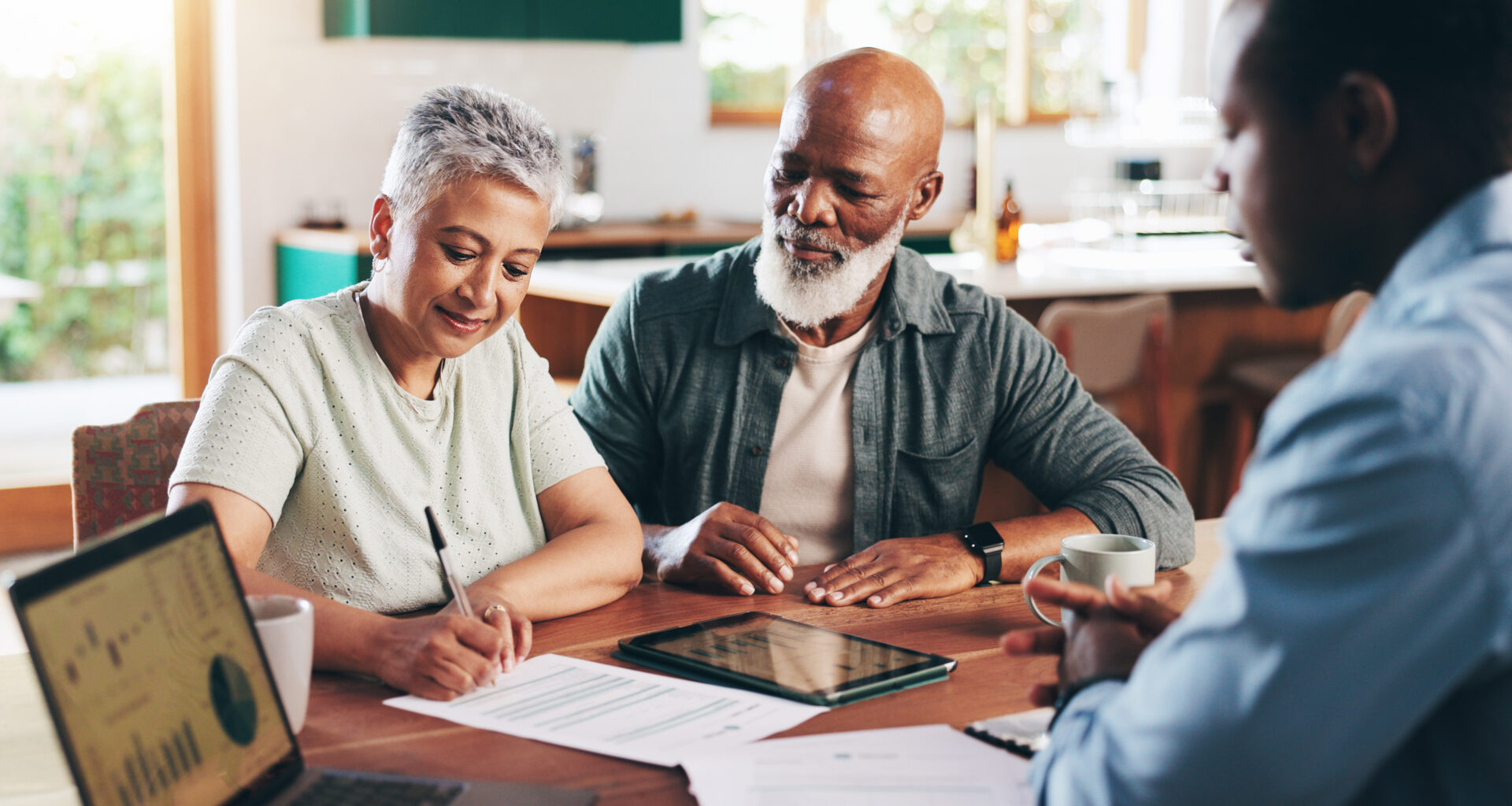 Retired couple with financial advisor planning for retirement fund