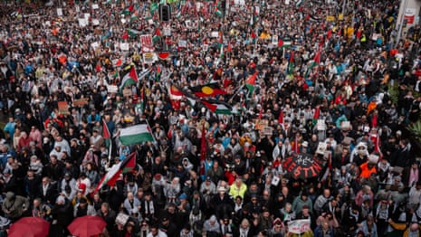 Thousands march across Sydney Harbour Bridge in one of biggest protests in city’s history – video