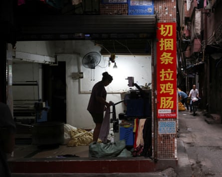 A person working outside of a factory at dusk