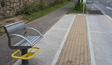This bus stop has a "bench" which provides seating for 1 person