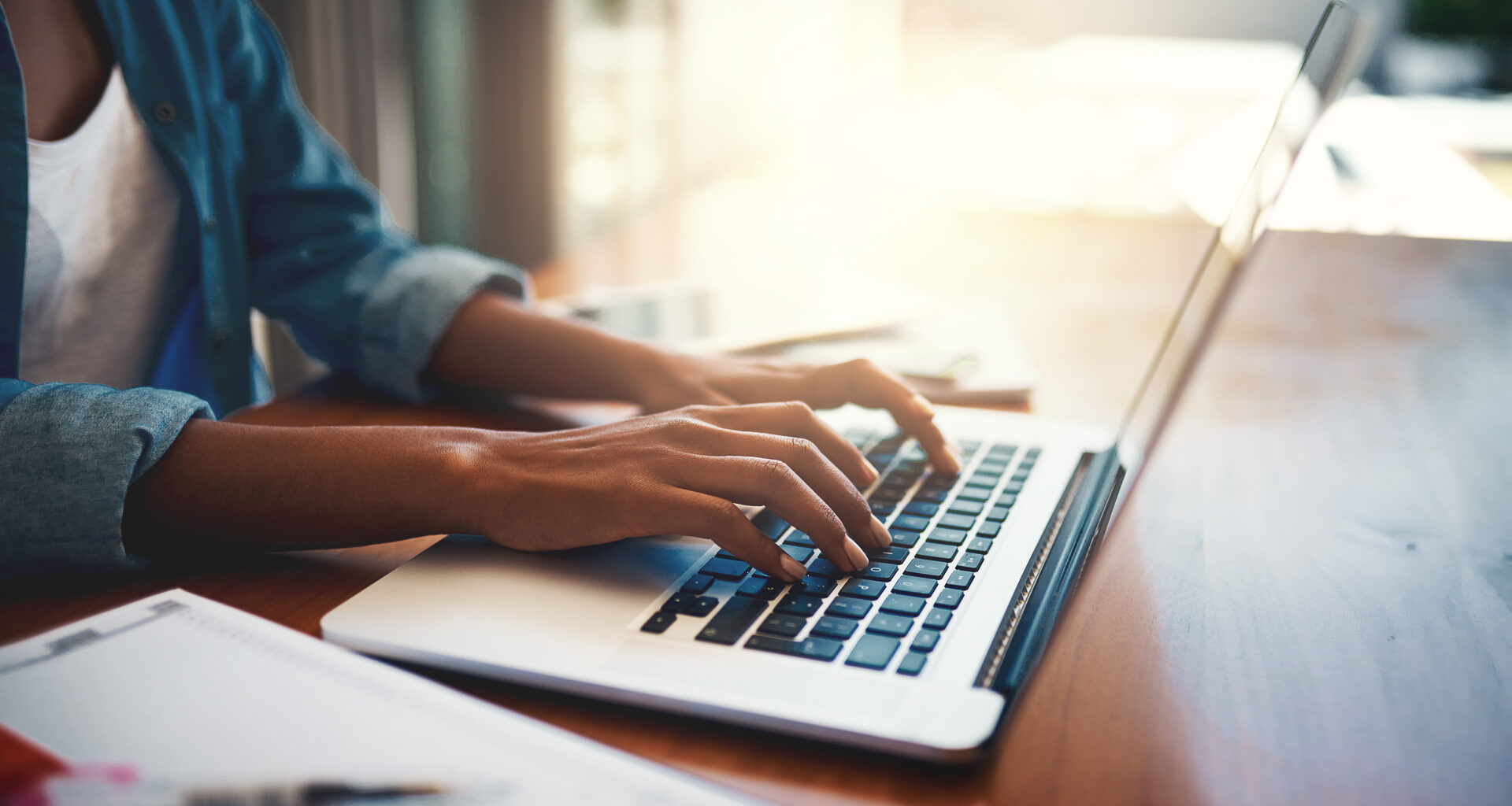 Closeup shot of an unrecognizable woman using a laptop while working from home.