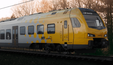 A yellow and grey stadler train