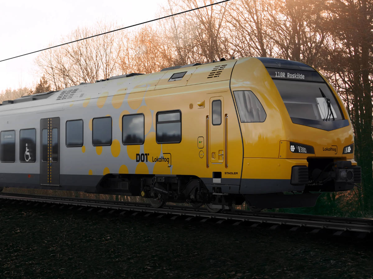 A yellow and grey stadler train
