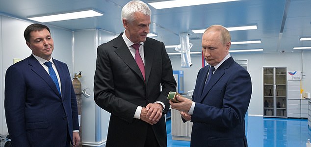 In this pool photograph distributed by Russian state agency Sputnik, Russia's President Vladimir Putin (R) speaks with Magadan region's Governor Sergei Nosov (C) during a visit of a plant of Omega-Sea entreprise in the far eastern port city of Magadan on the Sea of Okhotsk on August 15, 2025, ahead of his meeting with US' President. (Photo by Alexei NIKOLSKY / POOL / AFP) (Photo by ALEXEI NIKOLSKY/POOL/AFP via Getty Images)