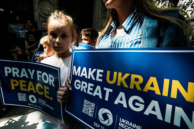 People attend a 'Rally for Peace', before U.S. President Donald Trump meets with Russian President Vladimir Putin in Alaska, at Saint George Ukrainian Catholic Church in New York City, U.S., August 15, 2025. REUTERS/Eduardo Munoz