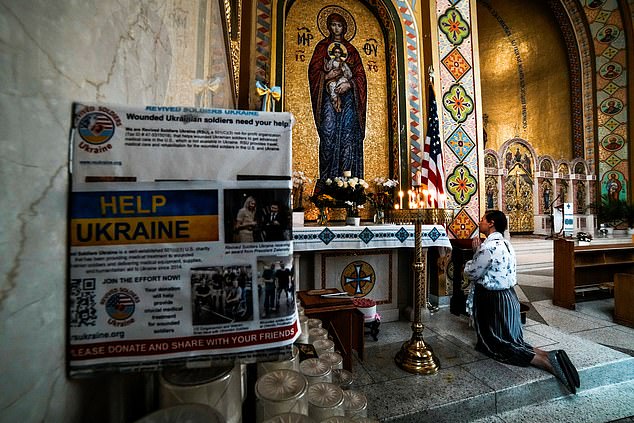A woman prays while people attend a 'Rally for Peace' before U.S. President Donald Trump meets with Russian President Vladimir Putin in Alaska, at Saint George Ukrainian Catholic Church in New York City, U.S., August 15, 2025. REUTERS/Eduardo Munoz