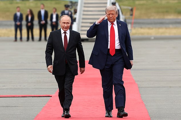 U.S. President Donald Trump walks with Russian President Vladimir Putin, as they meet to negotiate for an end to the war in Ukraine, at Joint Base Elmendorf-Richardson in Anchorage, Alaska, U.S., August 15, 2025. REUTERS/Kevin Lamarque