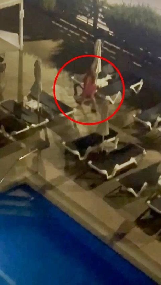 A woman removing towels from sunbeds