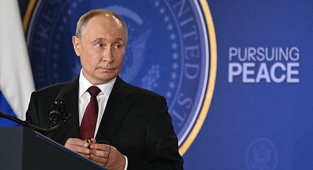 Russian President Vladimir Putin holds his earpiece during a joint press conference with US President Donald Trump (out of frame) after participating in a US-Russia summit on Ukraine at Joint Base Elmendorf-Richardson in Anchorage, Alaska, on August 15, 2025. (Photo by ANDREW CABALLERO-REYNOLDS / AFP) (Photo by ANDREW CABALLERO-REYNOLDS/AFP via Getty Images)