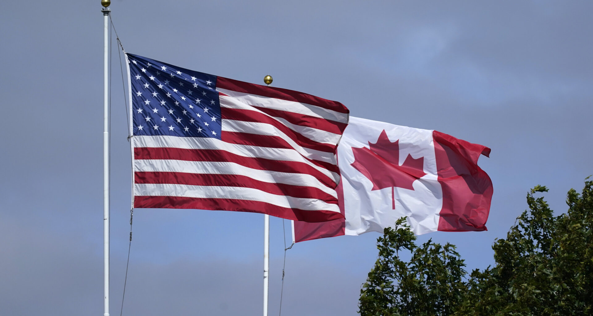 U.S. and Canadian flags fly together
