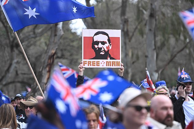 ADELAIDE, AUSTRALIA - AUGUST 31: A man holds a placard with an image of fugative Dezi Freeman at anti-immigration protesters march from Rundle Park on August 31, 2025 in Adelaide, Australia. Various right wing and nationalist groups have called for antiâ¿'immigration rallies across several Australian cities on August 31, citing concerns over border policies and cultural integration. Police and community leaders have warned of potential clashes, as counterâ¿'protests by proâ¿'diversity organisations are expected to take place simultaneously. (Photo by Tracey Nearmy/Getty Images)