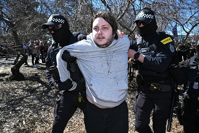 A anti fascist protester is arrested during the March for Australia anti-immigration rally in Canberra, Sunday, August 31, 2025. (AAP Image/Mick Tsikas) NO ARCHIVING