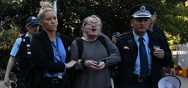 A woman is arrested by police after refusing to move on after yelling abuse at protesters during the National rally for Palestine in Sydney, Sunday, August 31, 2025. (AAP Image/Dean Lewins) NO ARCHIVING
