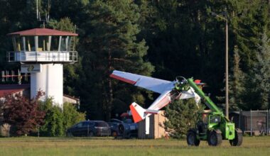 Das abgestürzte Flugzeug wird von einem Kran abtransportiert, im Hintergrund ist der Tower des Flugplatzes zu sehen. Bild: Michael Bahlo/dpa