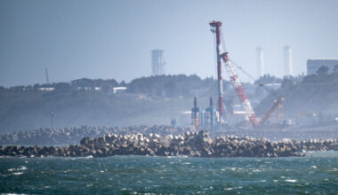 The Tokyo Electric Power Company's (TEPCO) crippled Fukushima Daiichi Nuclear Power Plant (back), is seen from Ukedo fishing port in Namie, Fukushima prefecture on Aug. 24, 2023. Japan began releasing wastewater from the crippled Fukushima nuclear plant into the Pacific Ocean on Aug. 24 despite angry opposition from China and local fishermen.