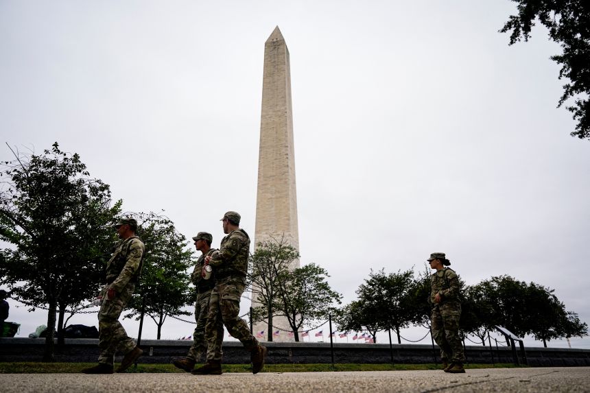 Members of the National Guard walk near the Washington Monument on August 21, 2025.