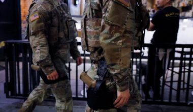 National Guard troops in Washington, DC, begin carrying weapons
