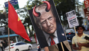 A demonstrator holds an image of U.S. President Donald Trump with red horns during a protest against the tariffs on Brazilian products imposed by Trump.