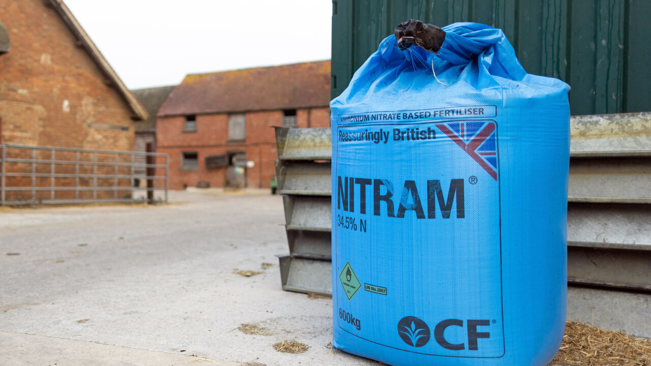 A sack of ammonium nitrate fertilizer in the yard of a dairy farm