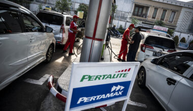 Attendants at a gas station owned by state-owned energy holding company Pertamina serve customers in Semarang, Central Java, on Feb. 27, 2025.