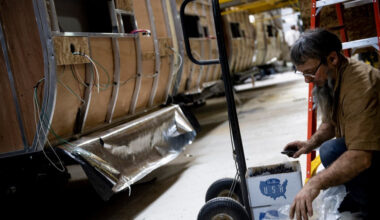 A worker opens boxes of screw at Riverside RV, builders of recreational vehicles, on January 24, 2020 in LaGrange, Indiana.