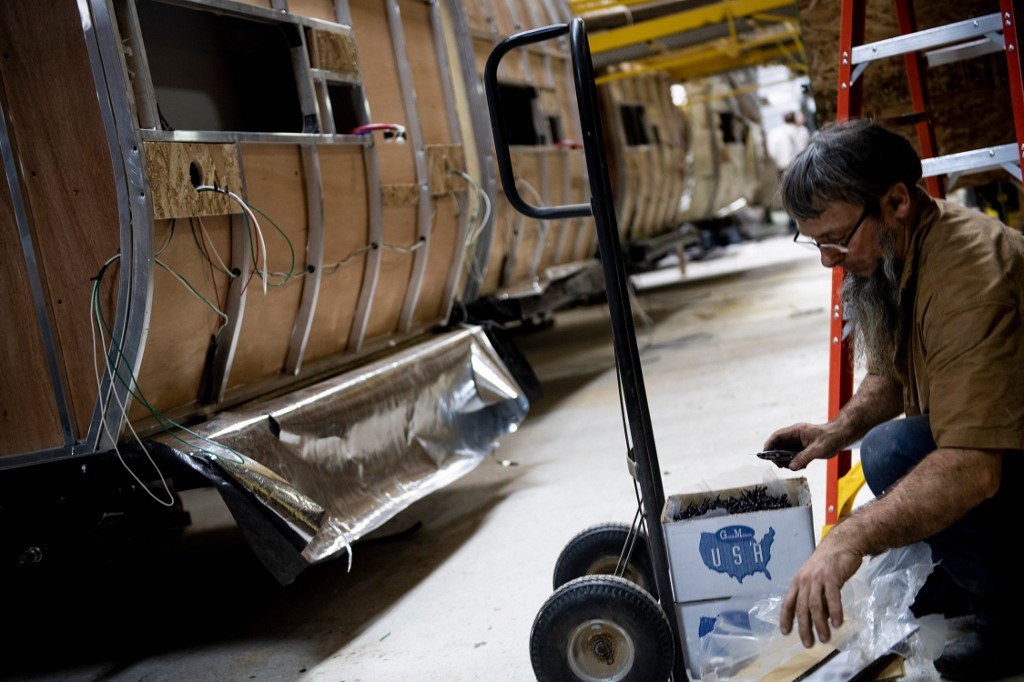 A worker opens boxes of screw at Riverside RV, builders of recreational vehicles, on January 24, 2020 in LaGrange, Indiana.
