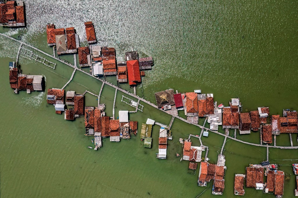 This photo taken on July 30, 2025 shows an aerial view of partially submerged houses due to land loss from climate change at Timbulsloko village in Demak, Central Java.