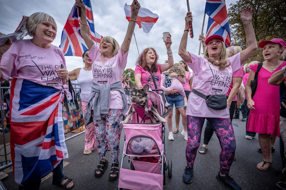 Epping Forest District of Essex, UK. 24th August 2025. ‘Pink Ladies’ movement, with pet dog mascot, join anti-migrant protesters near The Bell Hotel in Epping to continue demonstrations over the premises being used to house asylum seekers. The government is currently seeking the right to appeal against a High Court ruling which blocks asylum seekers being housed in the hotel. Credit: Guy Corbishley/Alamy Live News