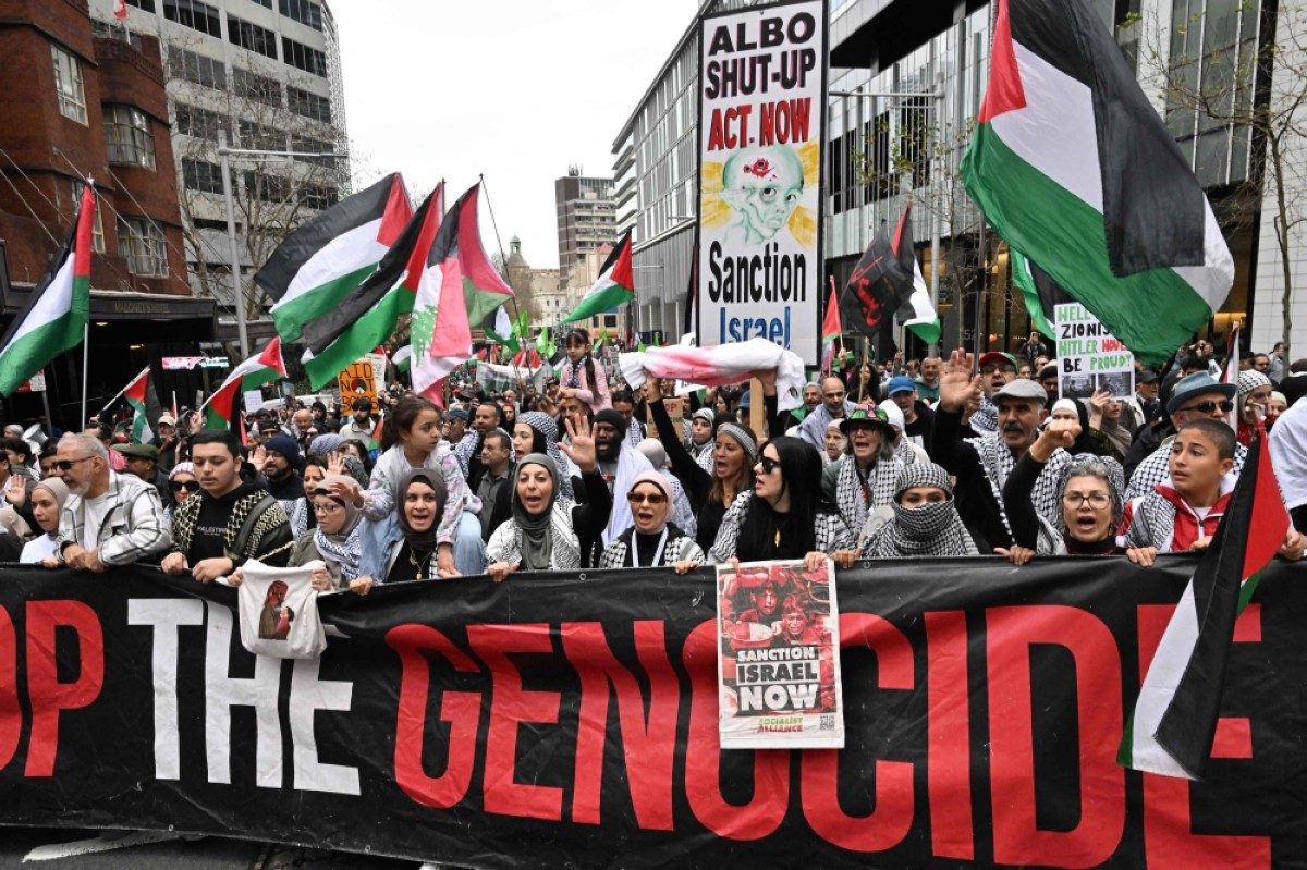 (Left) Demonstrators take part in a pro-Palestinian rally against Zionist actions and ongoing food shortages in the Gaza Strip during a protest in Sydney's central business district on Aug 24, 2025. (Right) People march with Palestinian flags and banners during a demonstration with the title 'All of Denmark on the Streets for a Free Palestine' in Copenhagen on Aug 24, 2025. - AFP photos