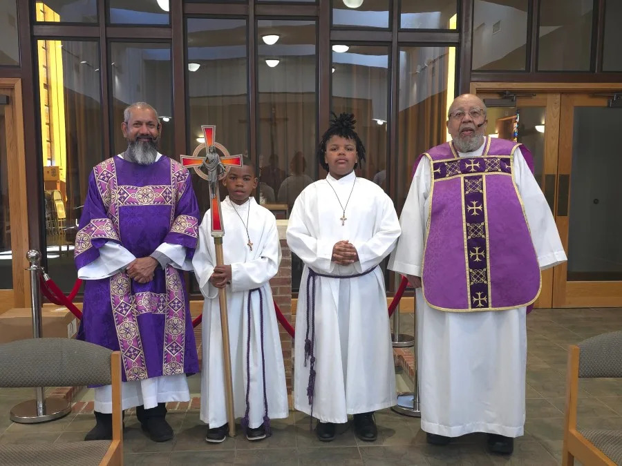 Deacon Denzil Lobo (far left) and Father Joseph Dyer (far right) pictured with student altar servers from Sister Thea Bowman Catholic School in Jackson, Mississippi for an April 2025 Mass (Courtesy: Chris Payne)