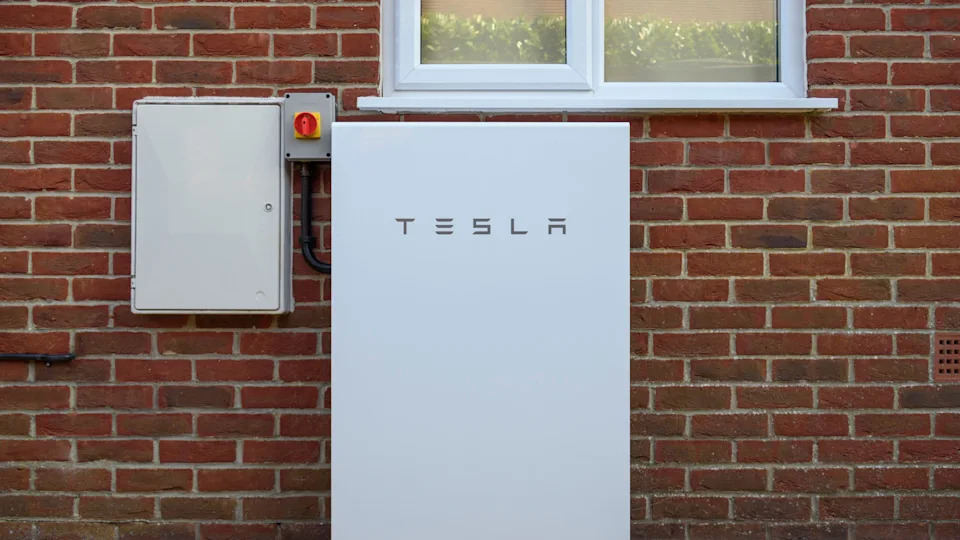 A solar-powered Tesla Powerwall 2 installed on the side of a home. (PA)
