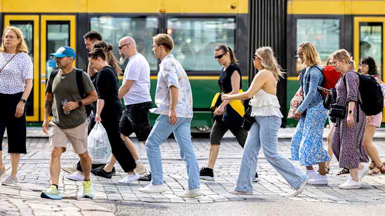 People walking in the street in summertime.