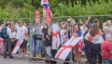anti-immigration protesters behind a fence