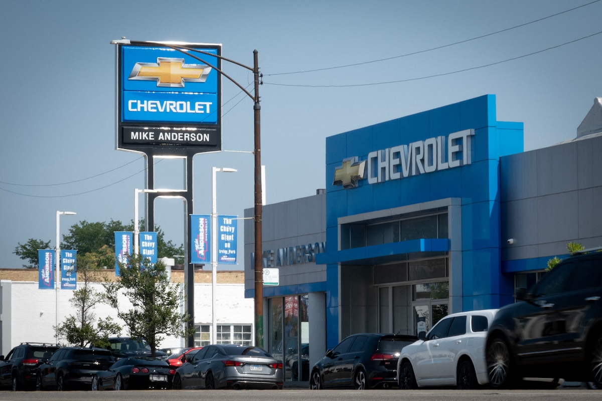 CHICAGO, ILLINOIS - JULY 22: A sign marks the location of a General Motors dealership on July 22, 2025 in Chicago, Illinois. General Motors, the maker of the Chevrolet, Buick, GMC, and Cadillac brands, reported a $1.1 billion drop in the second quarter net income compared with the same quarter in 2024, which it attributed to increased costs and industry uncertainty stemming from tariffs imposed by the Trump administration. Scott Olson/Getty Images/AFP (Photo by SCOTT OLSON / GETTY IMAGES NORTH AMERICA / Getty Images via AFP)