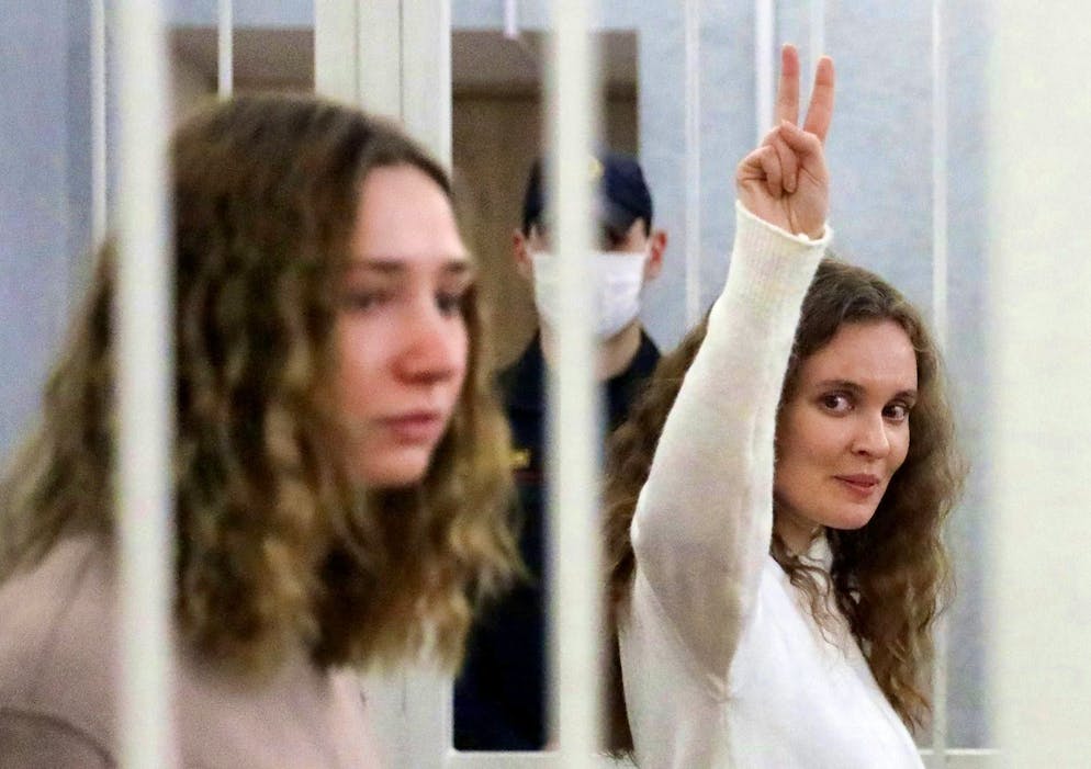 Journalist Katerina Bakhvalova makes the victory sign as she stands trial with her colleague Daria Chultsova in Minsk in February 2021: Women in prisons in Belarus can fare extremely badly.
