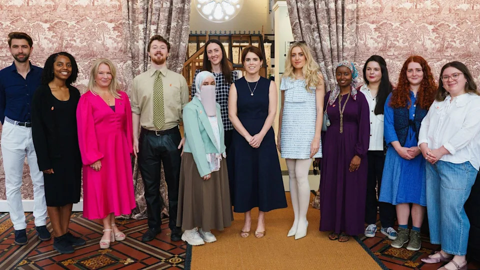 Princess Eugenie wearing a navy dress pictured with The King's Foundation 35 under 35 group