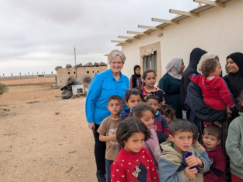 Wendy Housari joins children and mothers outside of the Church-donated school in the Mafraq refugee camp near Zarqa, Jordan, in March 2025.