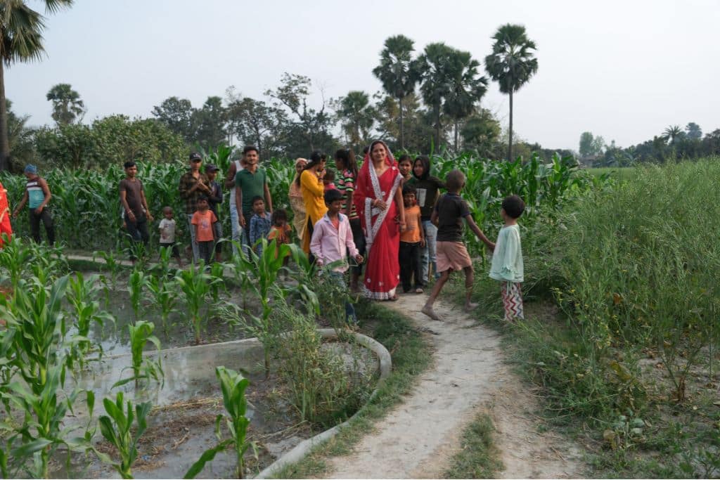 A local female leader in agriculture walks through her rural settlement in Muzaffarpur, Bihar.
