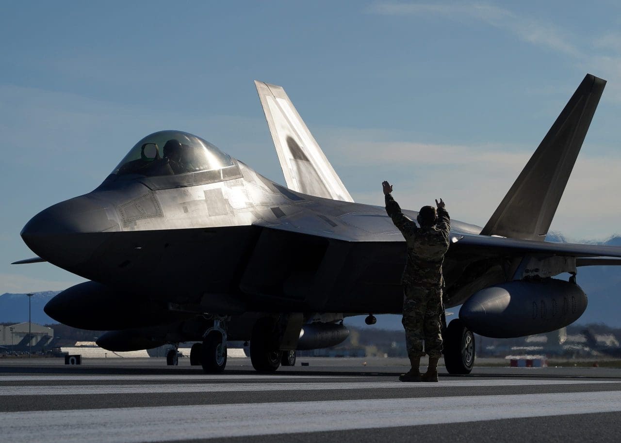 U.S. Air Force Staff Sgt. Christopher Graham, 3rd Wing crew chief, marshalls an F-22 Raptor on the flight line at Joint Base Elmendorf-Richardson, Alaska, during an elephant walk, May 5, 2020. The large show-of-force demonstrated the wings’ rapid mobility capabilities and response readiness during COVID-19 and also highlighted the ability to generate combat airpower at a moment’s notice to ensure regional stability throughout the North American Aerospace Defense Command Region and Indo-Pacific. (U.S. Air Force photo by Tech. Sgt. Westin Warburton)