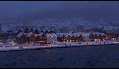 A moody winter night at Bryggen in Bergen with ice on the water
