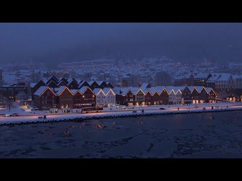 A moody winter night at Bryggen in Bergen with ice on the water