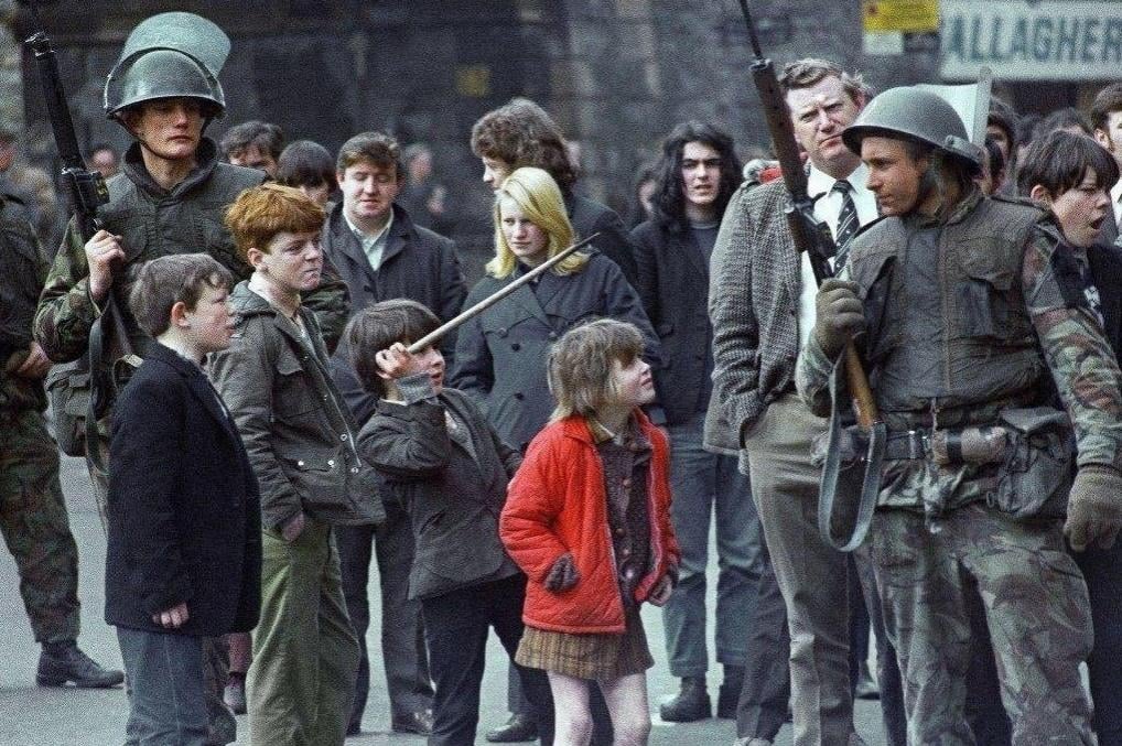 Irish children tease British soldiers. Derry, 1972.
