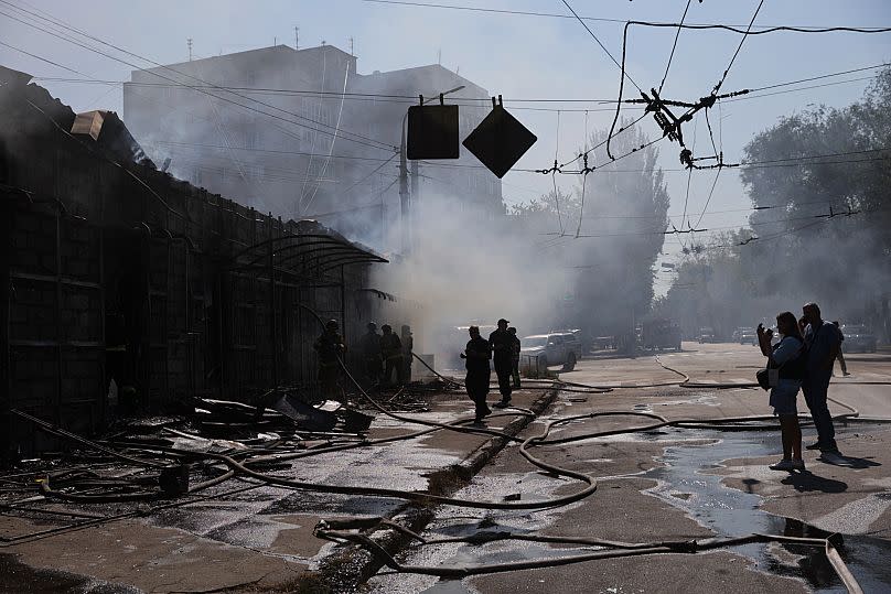 Rescue workers put out a fire at commercial stores destroyed by a Russian missile attack on Zaporizhzhia, 18 August, 2025